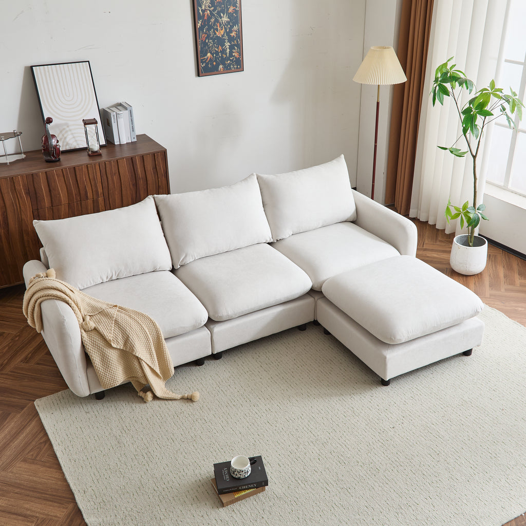 Top angled view of white 4-piece L shaped modular sectional sofa with ottoman, placed on a beige rug in a bright living room.