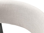 Detailed view of the curved cushioned backrest upholstered in beige fabric on a contemporary counter height chair.