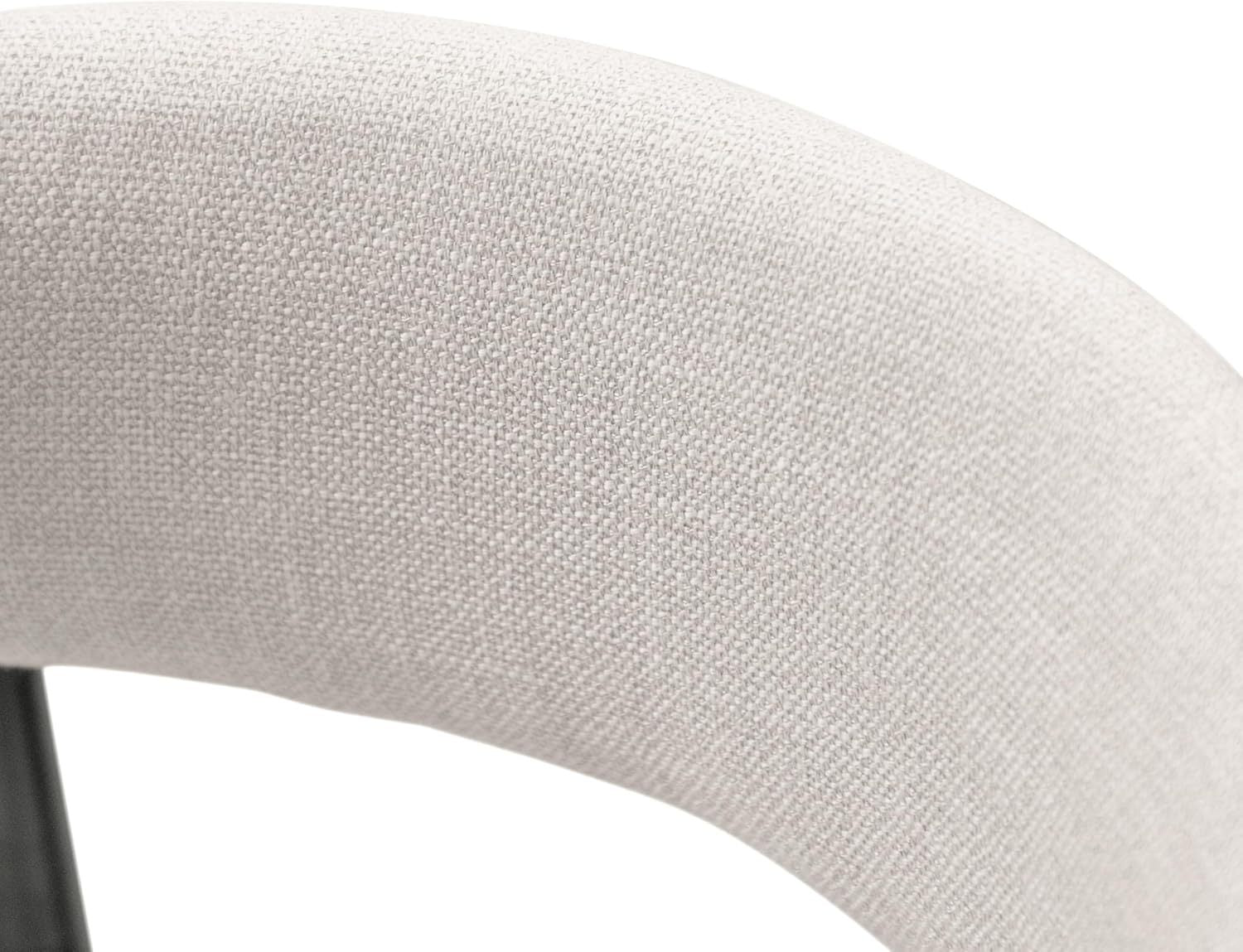 Detailed view of the curved cushioned backrest upholstered in beige fabric on a contemporary counter height chair.