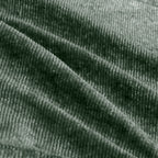 Close-up of green velvet fabric texture used in the Modular Sofa, highlighting its soft, ribbed surface and premium quality.