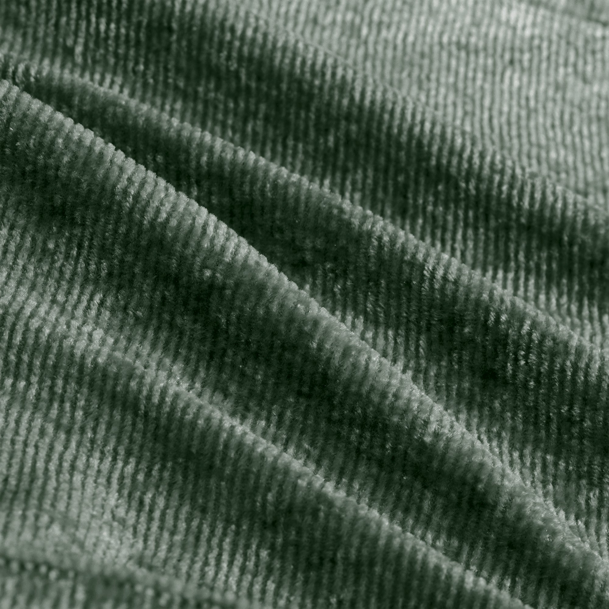 Close-up of green velvet fabric texture used in the Modular Sofa, highlighting its soft, ribbed surface and premium quality.