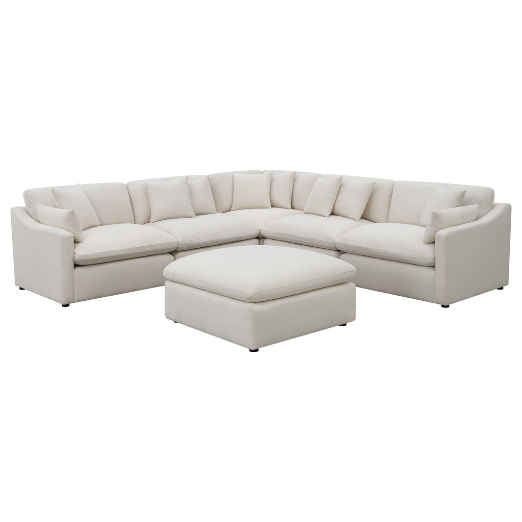 Modern ivory 6-piece modular sectional sofa with reversible plush cushions and a matching square ottoman.