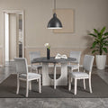 5pc dining set with gray upholstered chairs and round table.