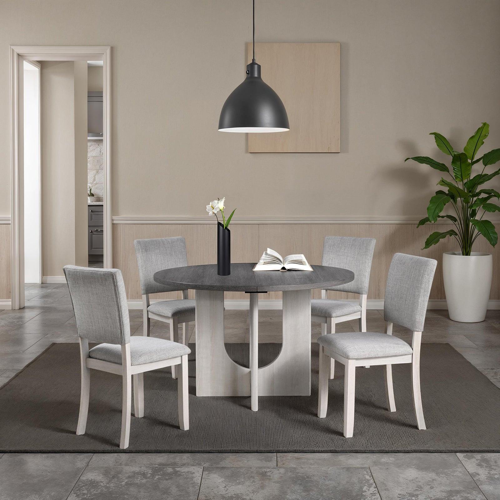 5pc dining set with gray upholstered chairs and round table.