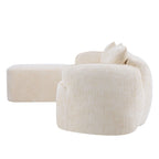 Angled rear view of L-shaped beige chenille sofa with curved armrest and plush back cushions for modern interiors.