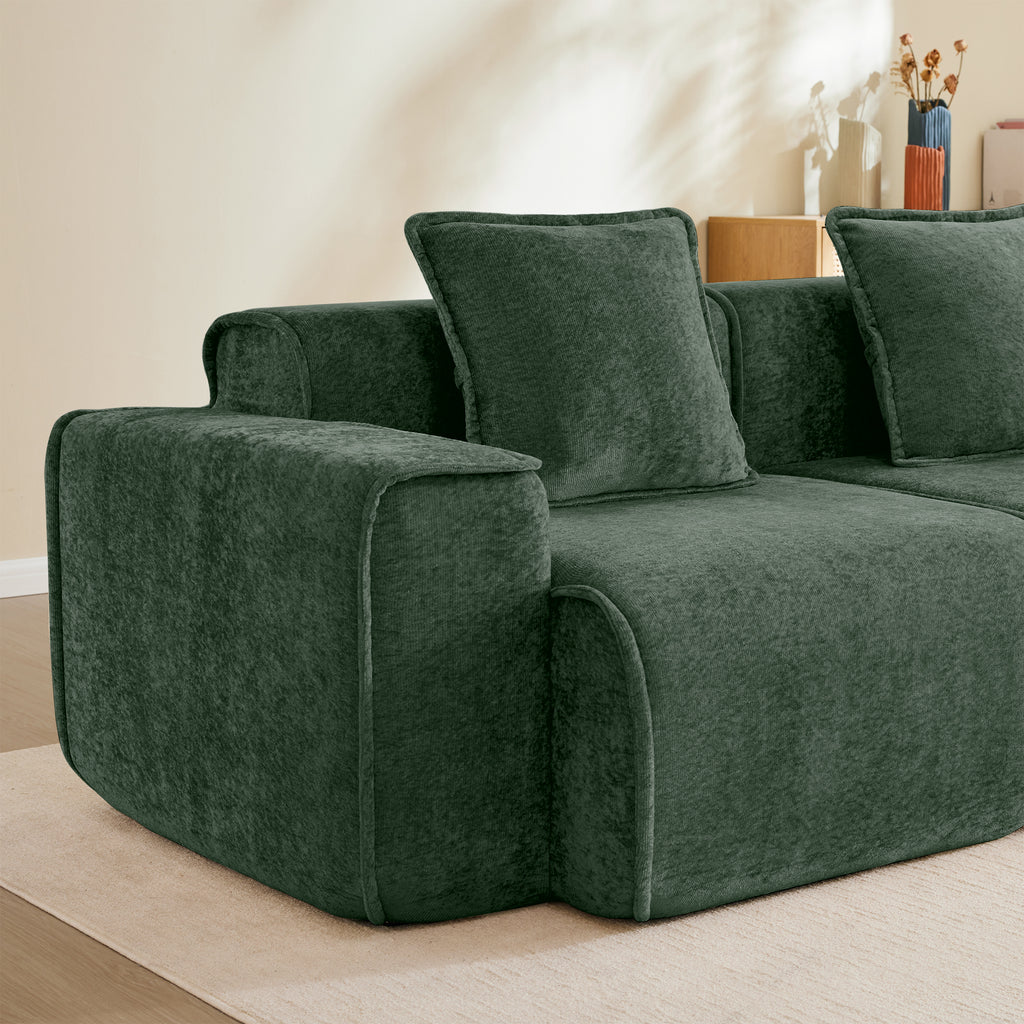 Left armrest of the Modular Green Velvet Sofa with plush cushion, highlighting the sofa's premium build and cozy seating.
