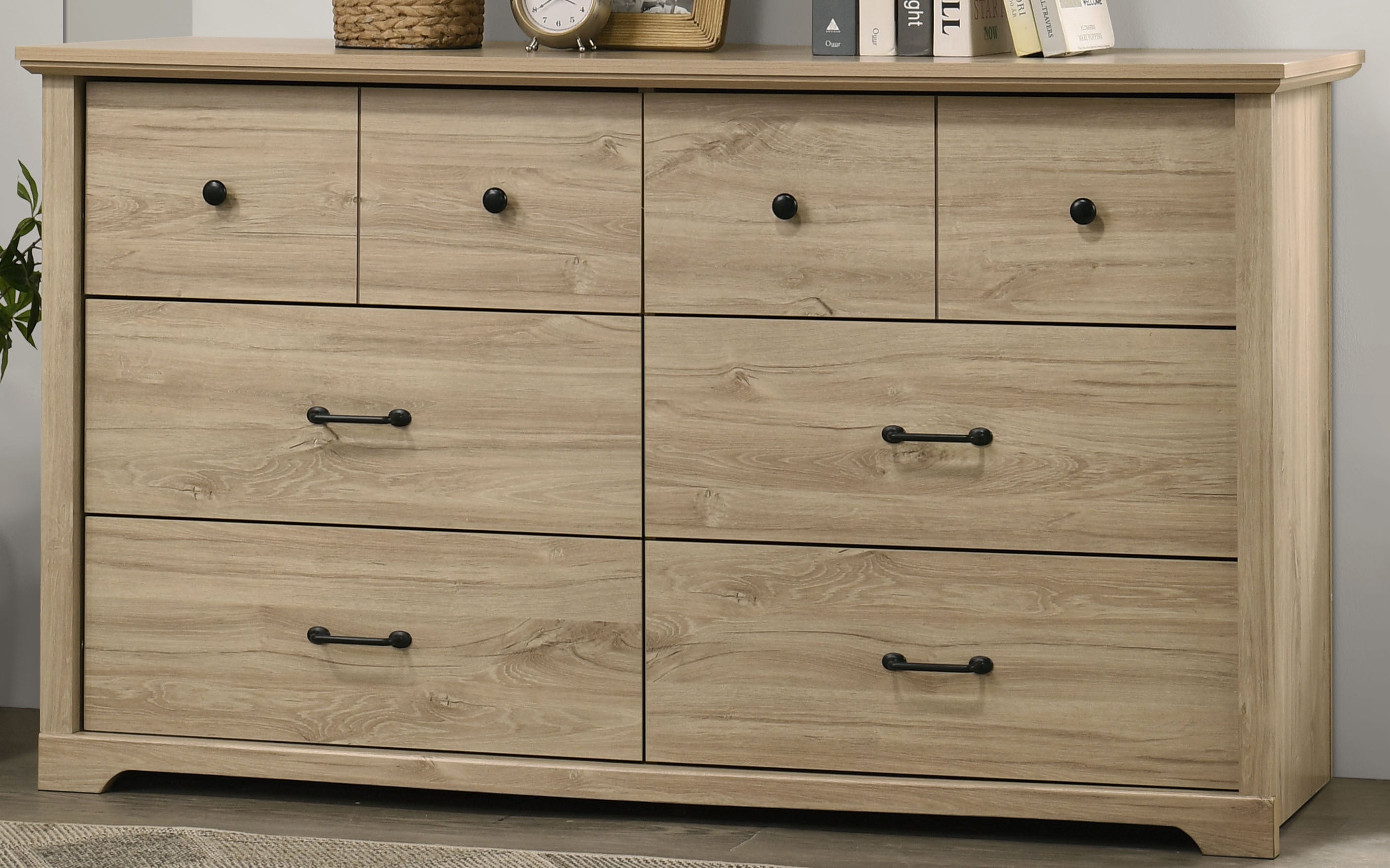 Close-up of Elara Light Oak 6-Drawer Dresser highlighting modern black metal handles and natural wood grain finish.