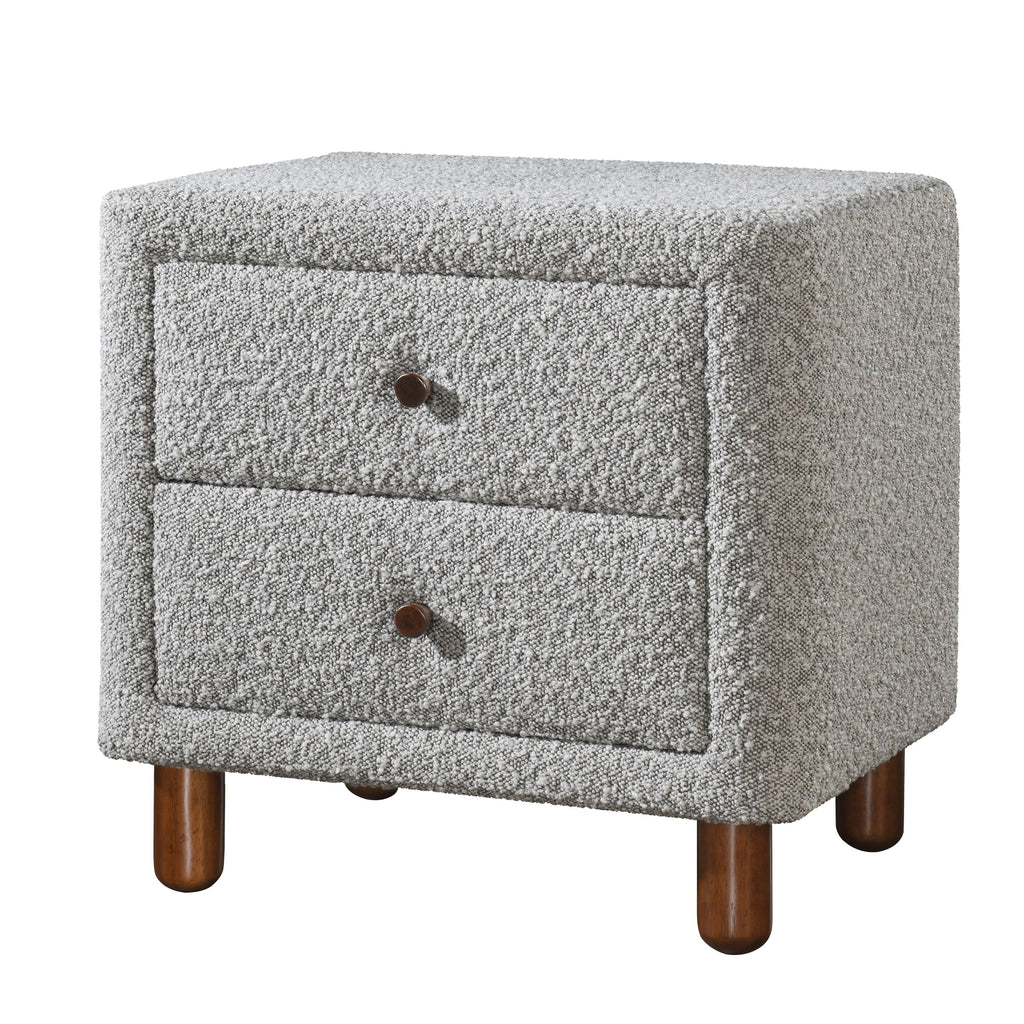 Grey boucle upholstered nightstand featuring two drawers with dark wooden knobs on short, rounded wooden legs.