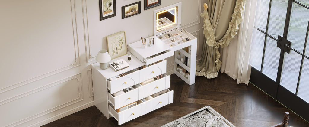 Top-down view of vanity desk with mirror and lights, flip-top open with cosmetics neatly arranged in storage sections.