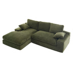 Top view of green corduroy sofa with chaise, cushions, and pillows, showcasing its soft texture and spacious seating area.