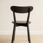 Back view of black Solid Oak Dining Chair showcasing its sturdy frame and smooth wood grain texture.