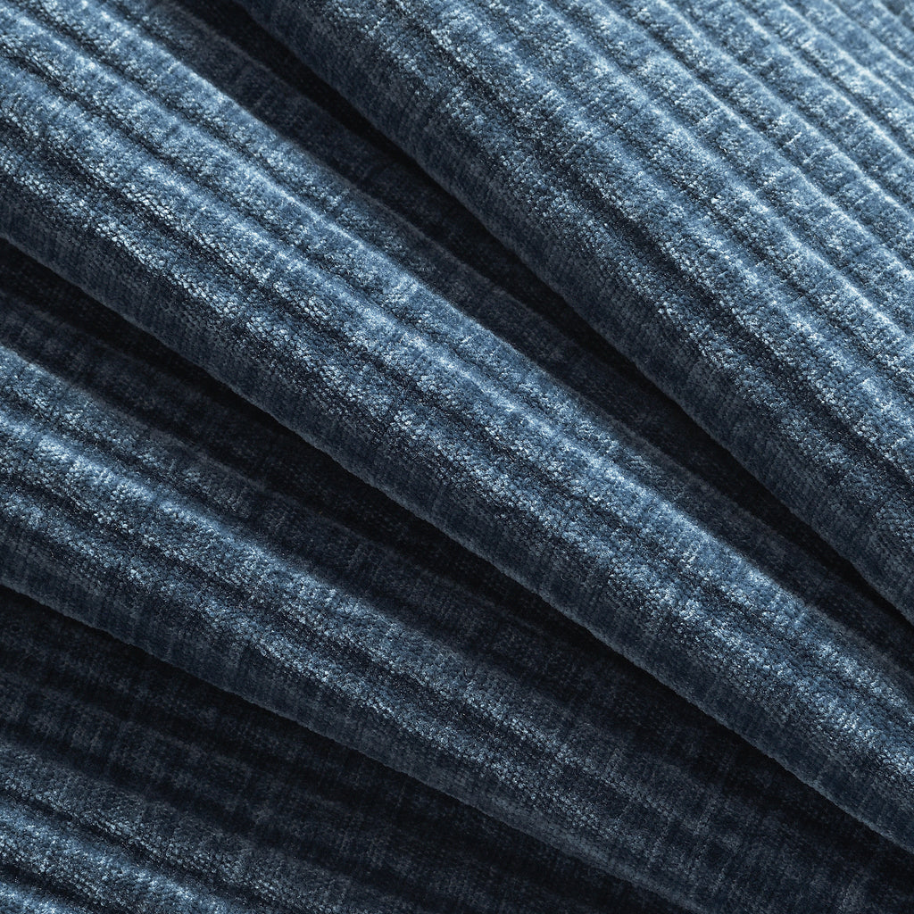Close-up of textured blue upholstery fabric used on modular sectional sofa, highlighting its soft and durable material.