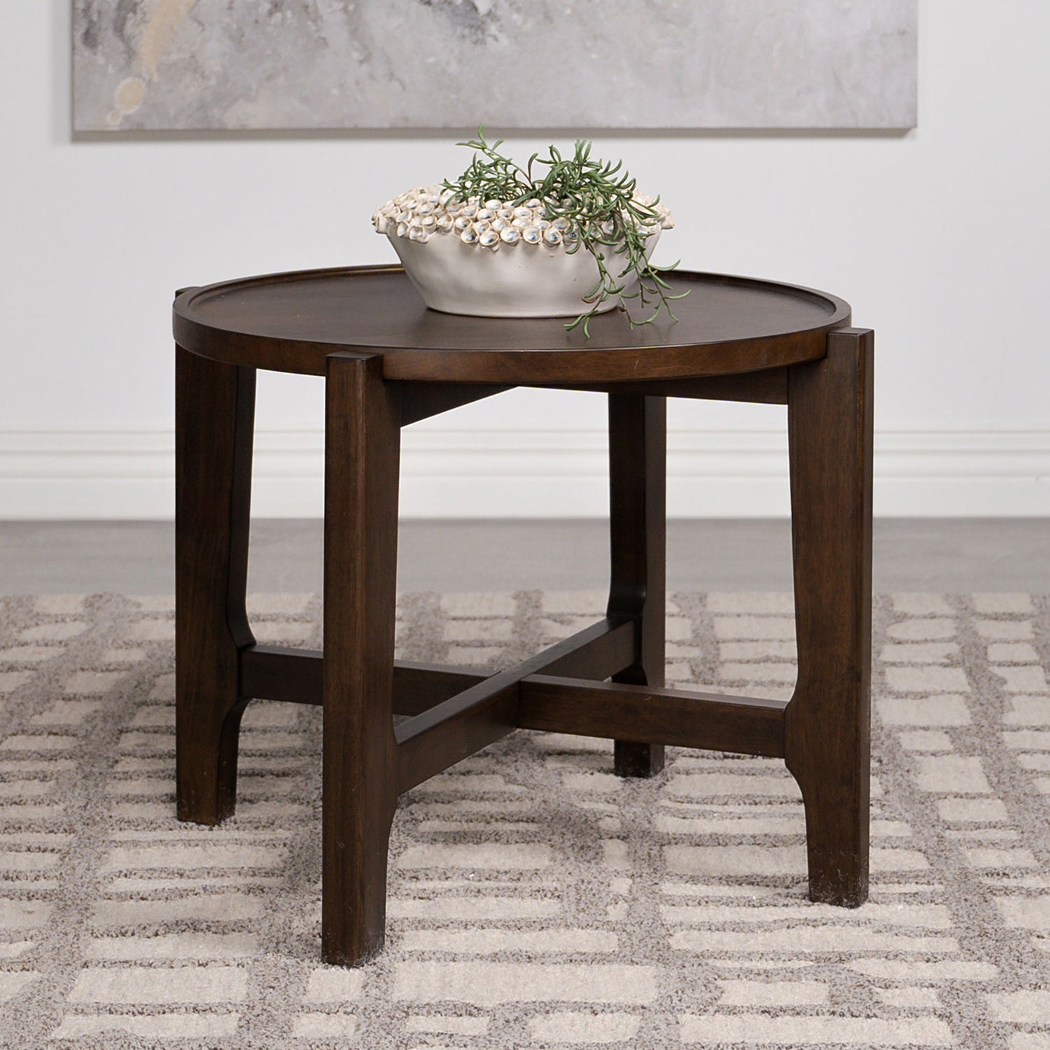 Round dark brown rubberwood end table styled in a modern living room, showcasing its elegant finish and compact design.