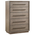 Taupe oak 5-drawer chest featuring mitered trim, recessed base, and minimalist metal pulls in a warm neutral finish.