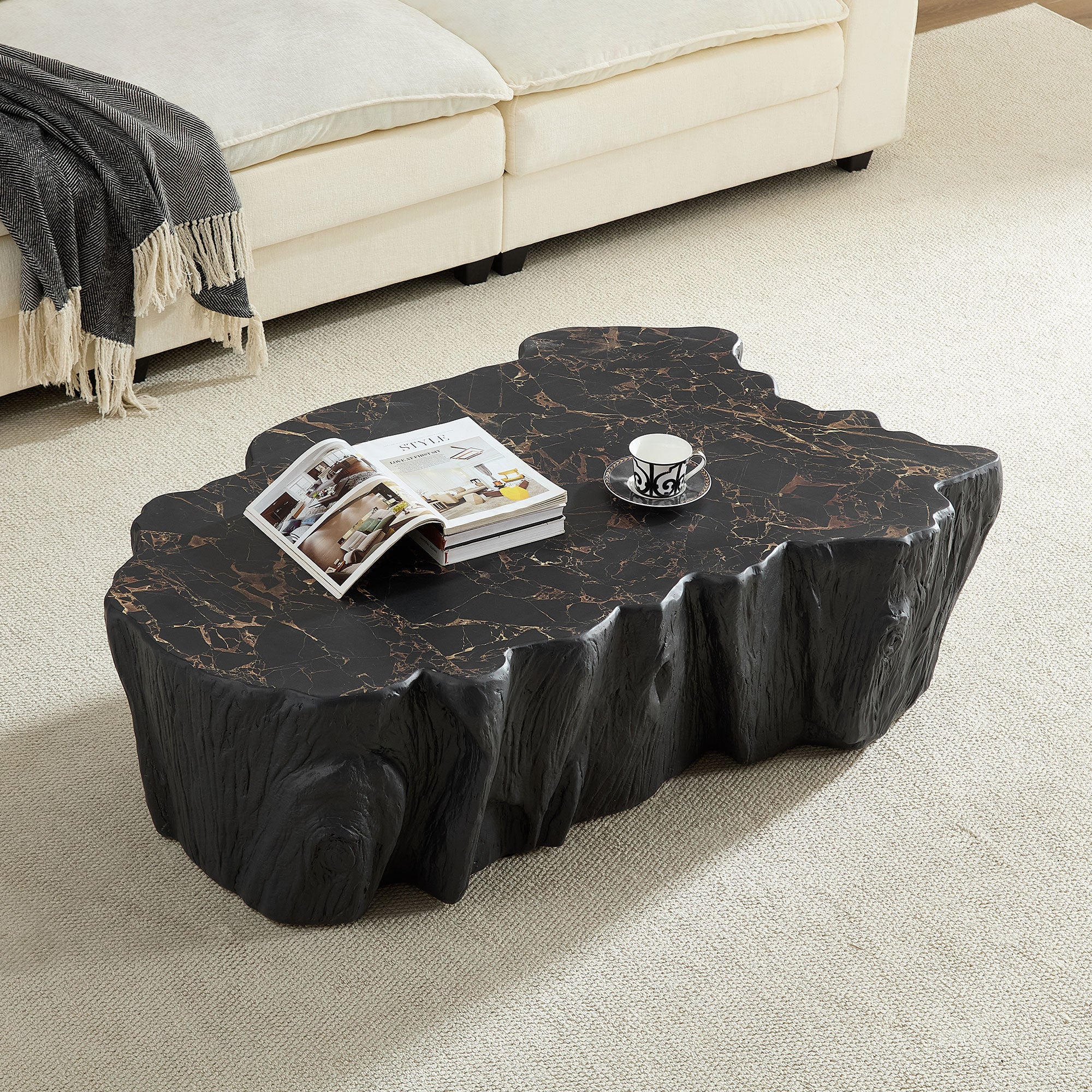 Black fiberglass coffee table with realistic wood grain and marble top, styled in a cozy living room with cream sofa and neutral decor.