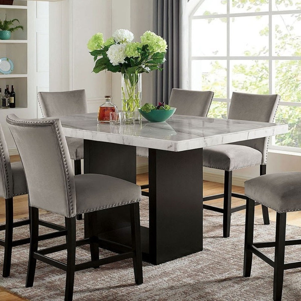 Counter height genuine marble dining table with solid wood base and six gray chairs, styled in a transitional dining room setting.