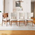 Set of 4 Mid-Century Modern Dining Chairs with ergonomic backrests and beige upholstery in a bright dining room setting.
