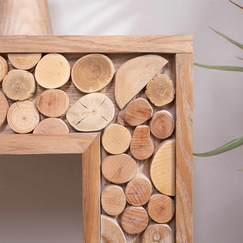 Close-up of natural log accents on rustic wood console table, highlighting the unique textures and handcrafted wood slices.