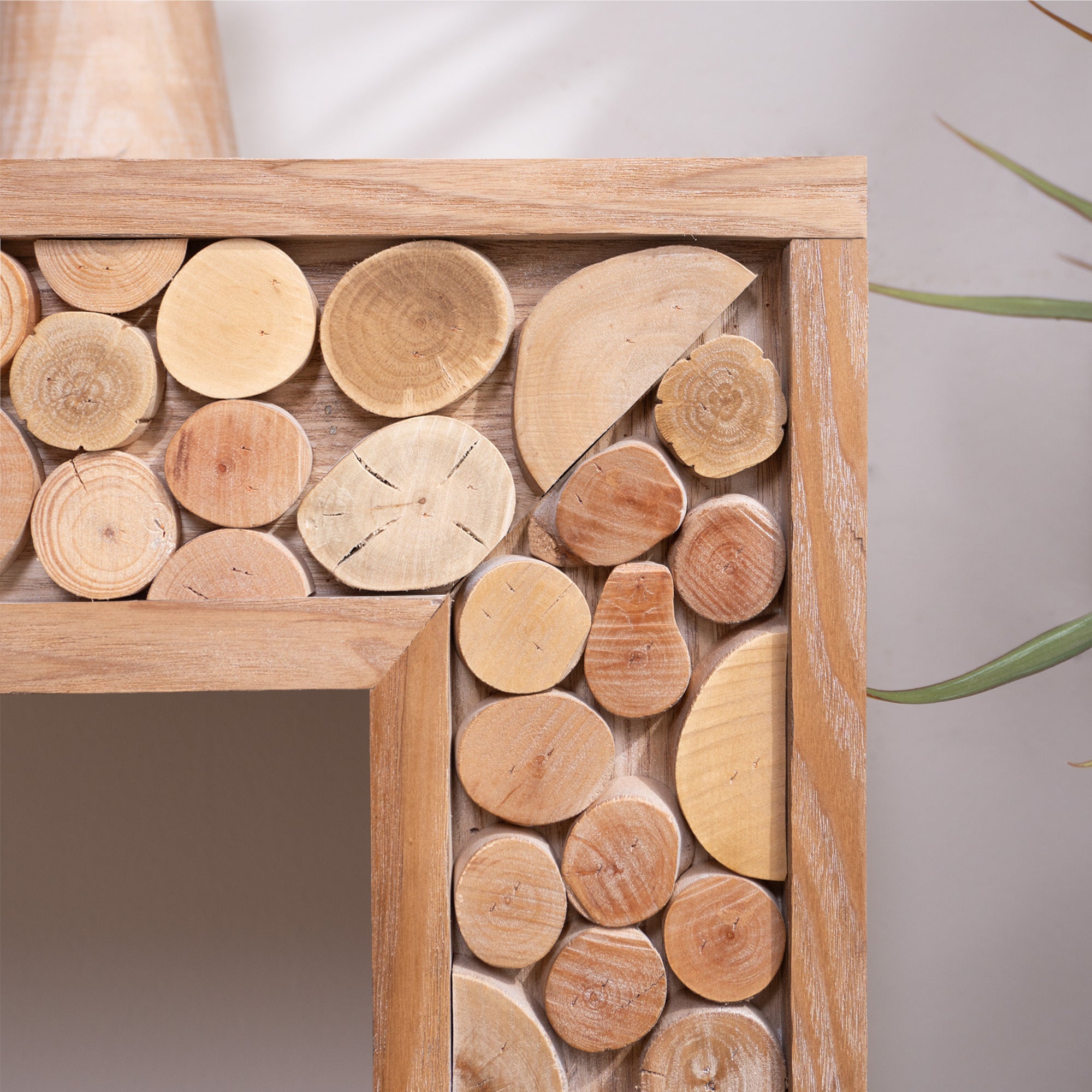 Close-up of natural log accents on rustic wood console table, highlighting the unique textures and handcrafted wood slices.
