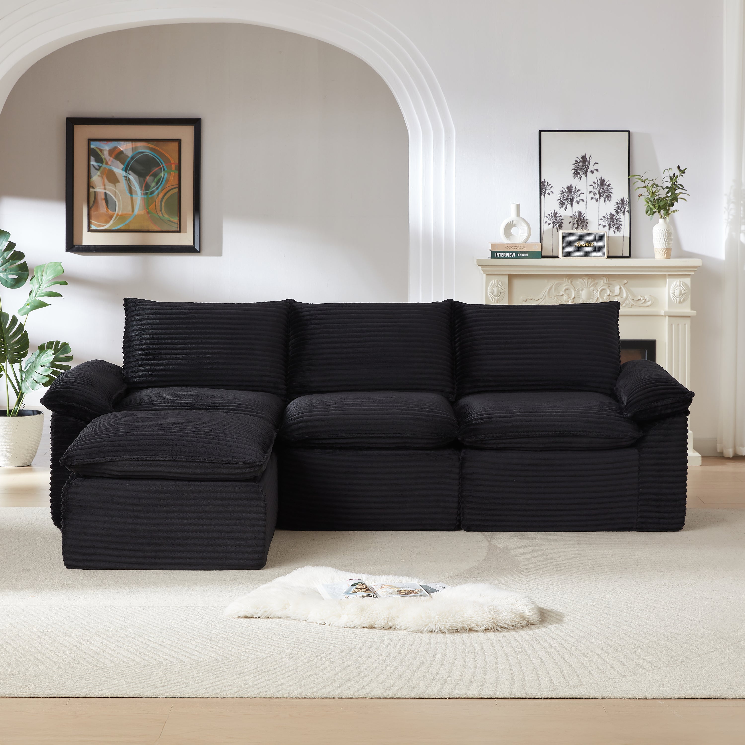 Modern black corduroy modular sofa with left-facing chaise, set in a cozy living room. Great for durable and comfortable seating arrangements.