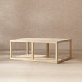 Rectangular coffee table in light natural reclaimed pine with an open-frame design and a lower storage shelf.