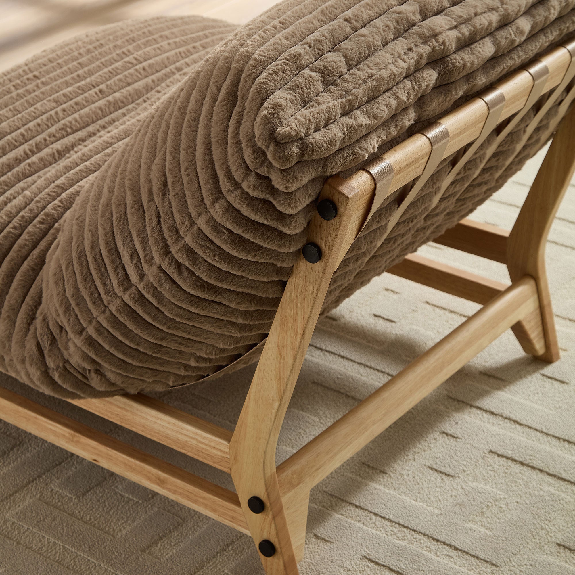 Angled view of corduroy chair's wooden frame and ribbed cushion, blending comfort with a modern rustic aesthetic.