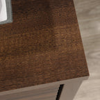 Top surface detail of the Library Base, Brown finish cabinet, showing rich wood grain texture and smooth finish.