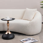 Side view of white curved sofa with accent table, perfect for modern living spaces with minimalist aesthetics.