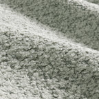 Close-up texture of boucle fabric used on the modular sectional sofa with ottoman, emphasizing softness and durability.