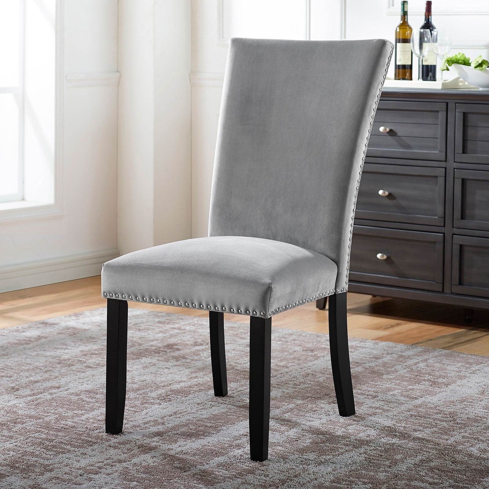 Single grey upholstered dining chair with black legs from 7pc marble dining table set. Elegant and comfortable seating option.
