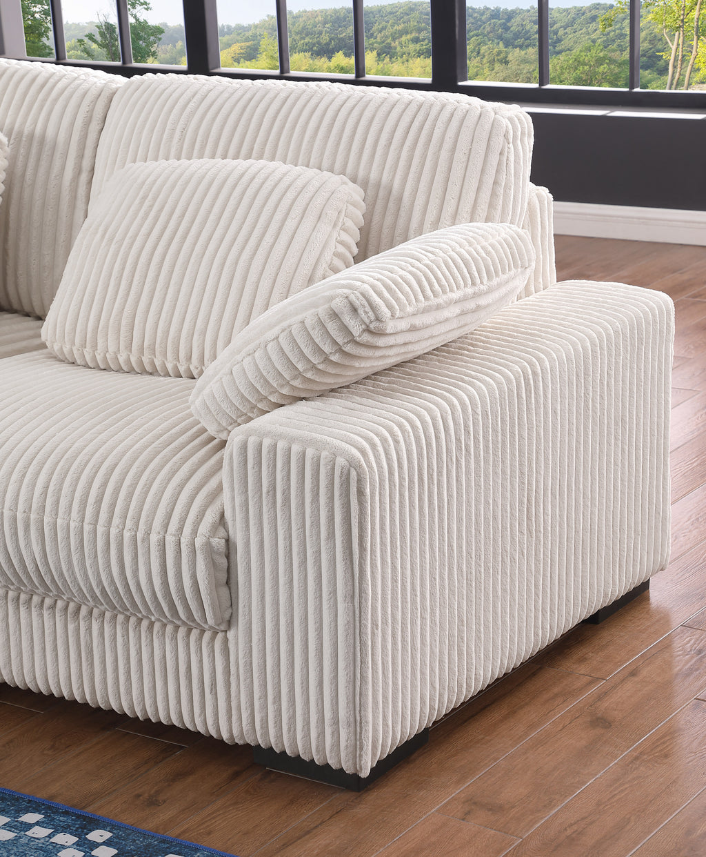 Armrest and cushion detail of Beige Corduroy Corner Sofa, showcasing thick padding and soft ribbed fabric for comfort.