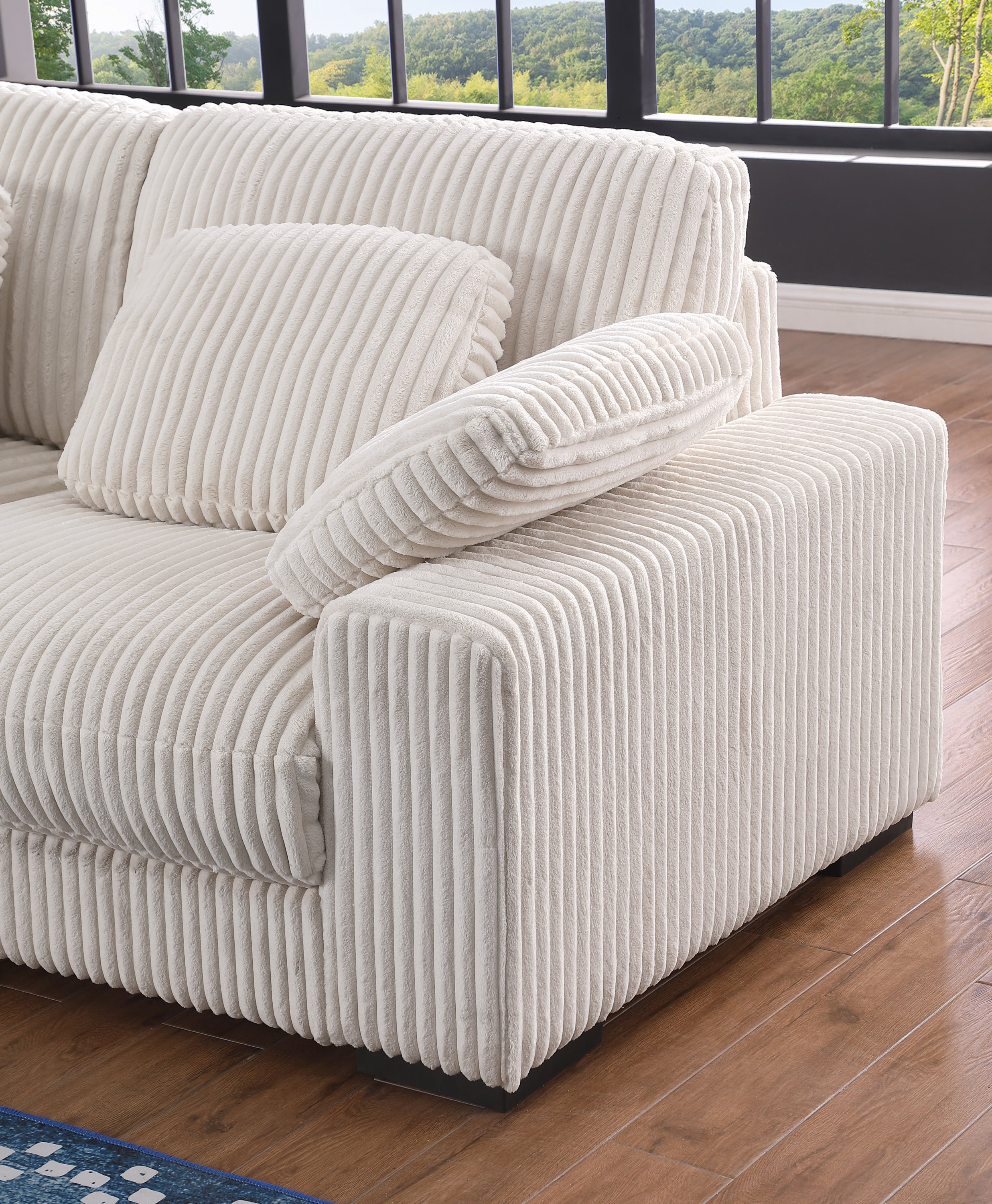 Armrest and cushion detail of Beige Corduroy Corner Sofa, showcasing thick padding and soft ribbed fabric for comfort.