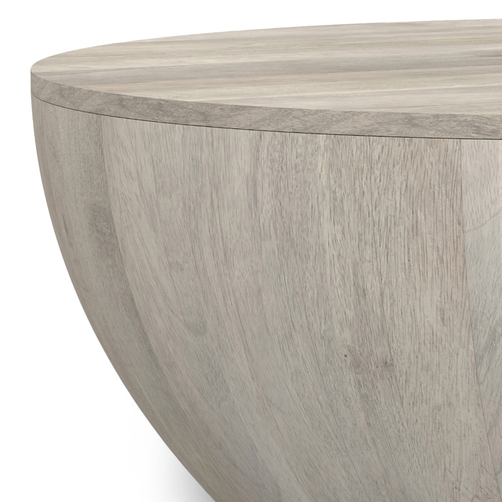 Close-up of the Elmbrook Drum Coffee Table's rustic white wood texture, highlighting the smooth finish and natural wood grain detail.