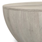 Close-up of the Elmbrook Drum Coffee Table's rustic white wood texture, highlighting the smooth finish and natural wood grain detail.