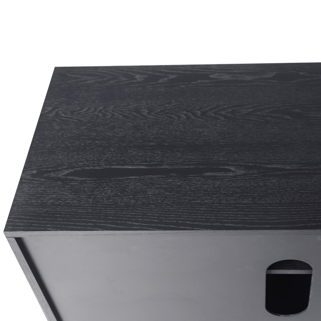 Detail of black wood veneered surface on TV console, showcasing natural wood grain texture and high-quality lacquered finish.