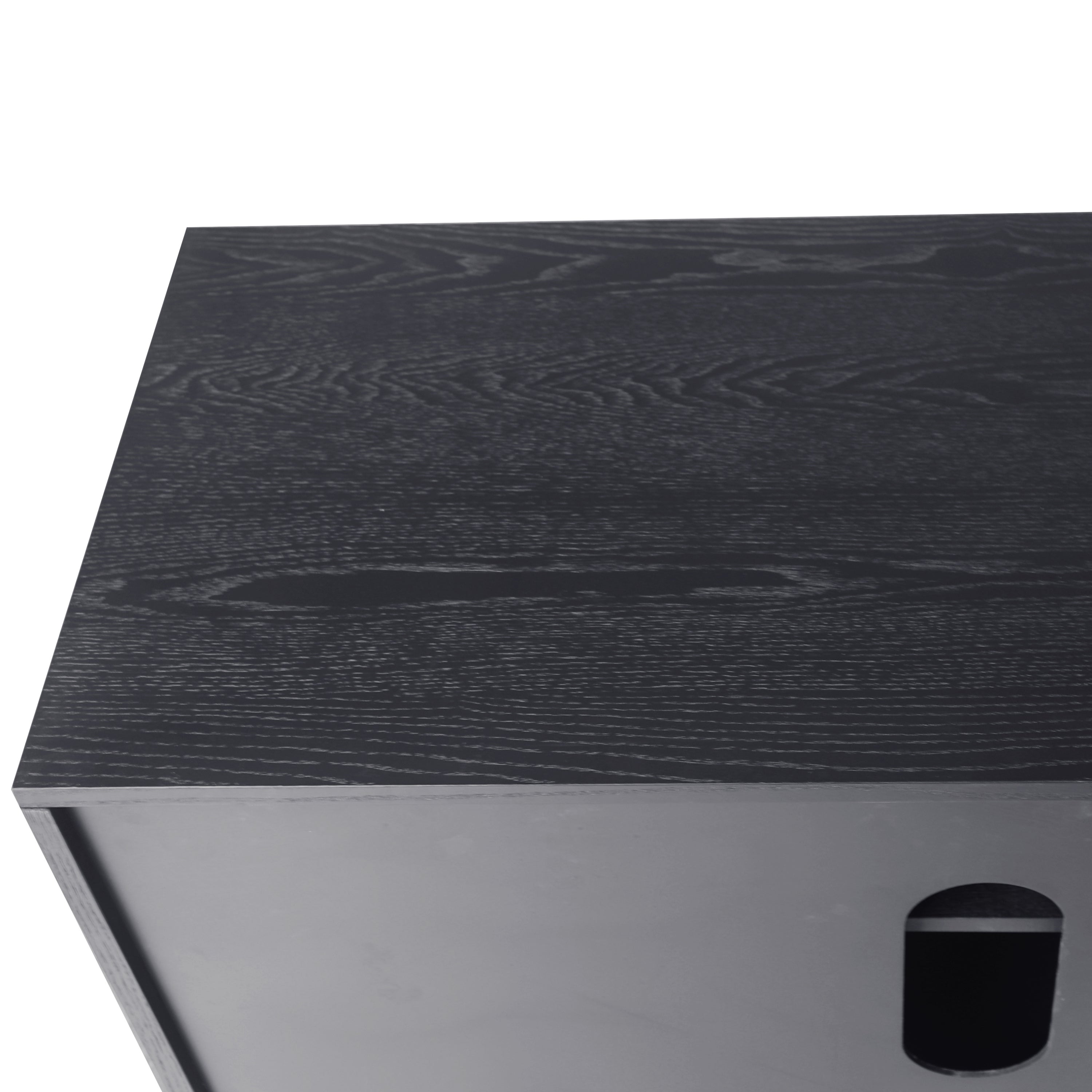 Detail of black wood veneered surface on TV console, showcasing natural wood grain texture and high-quality lacquered finish.