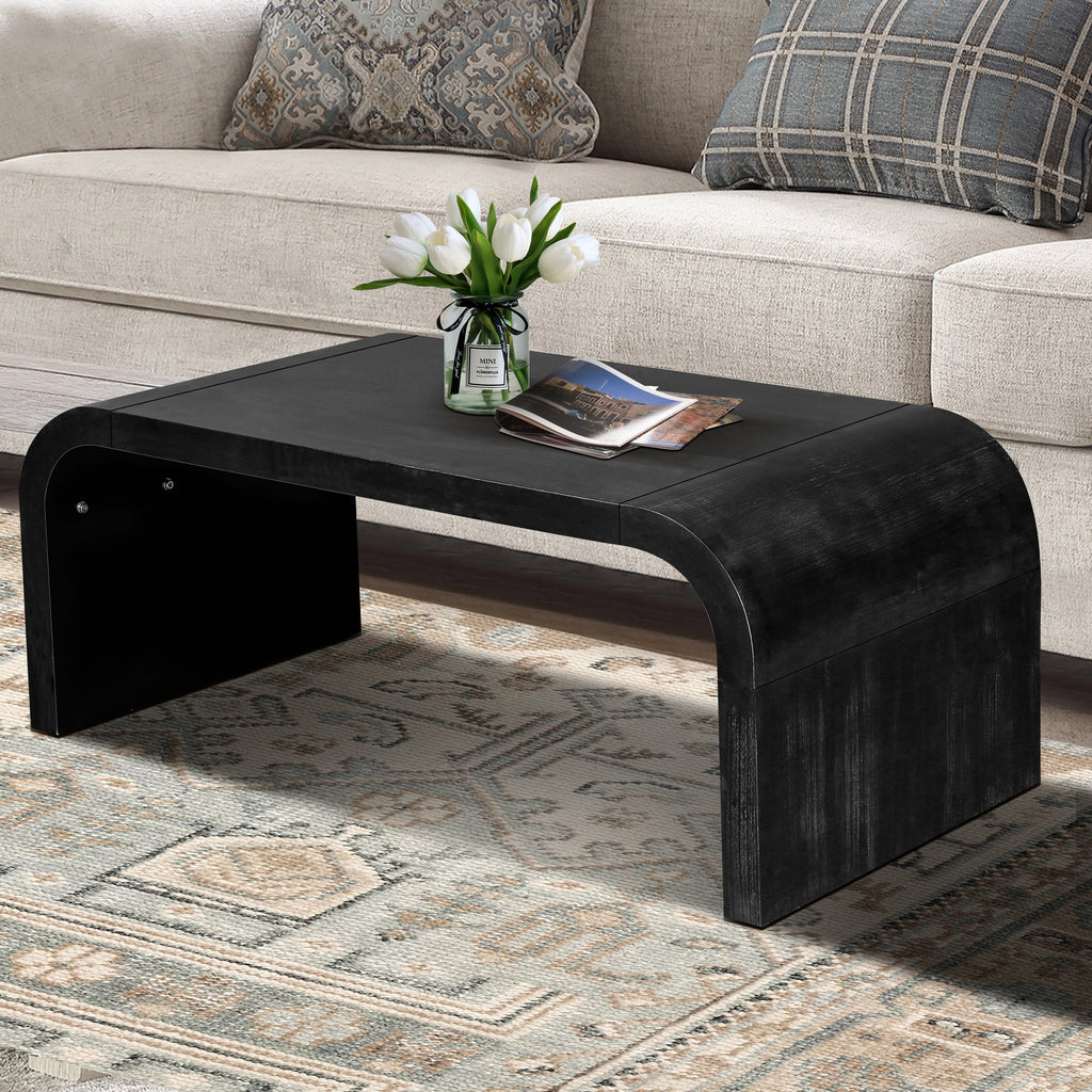 Vintage Farmhouse Coffee Table with curved edges and black wood grain finish, placed in a rustic living room with patterned rug.