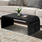 Vintage Farmhouse Coffee Table with curved edges and black wood grain finish, placed in a rustic living room with patterned rug.
