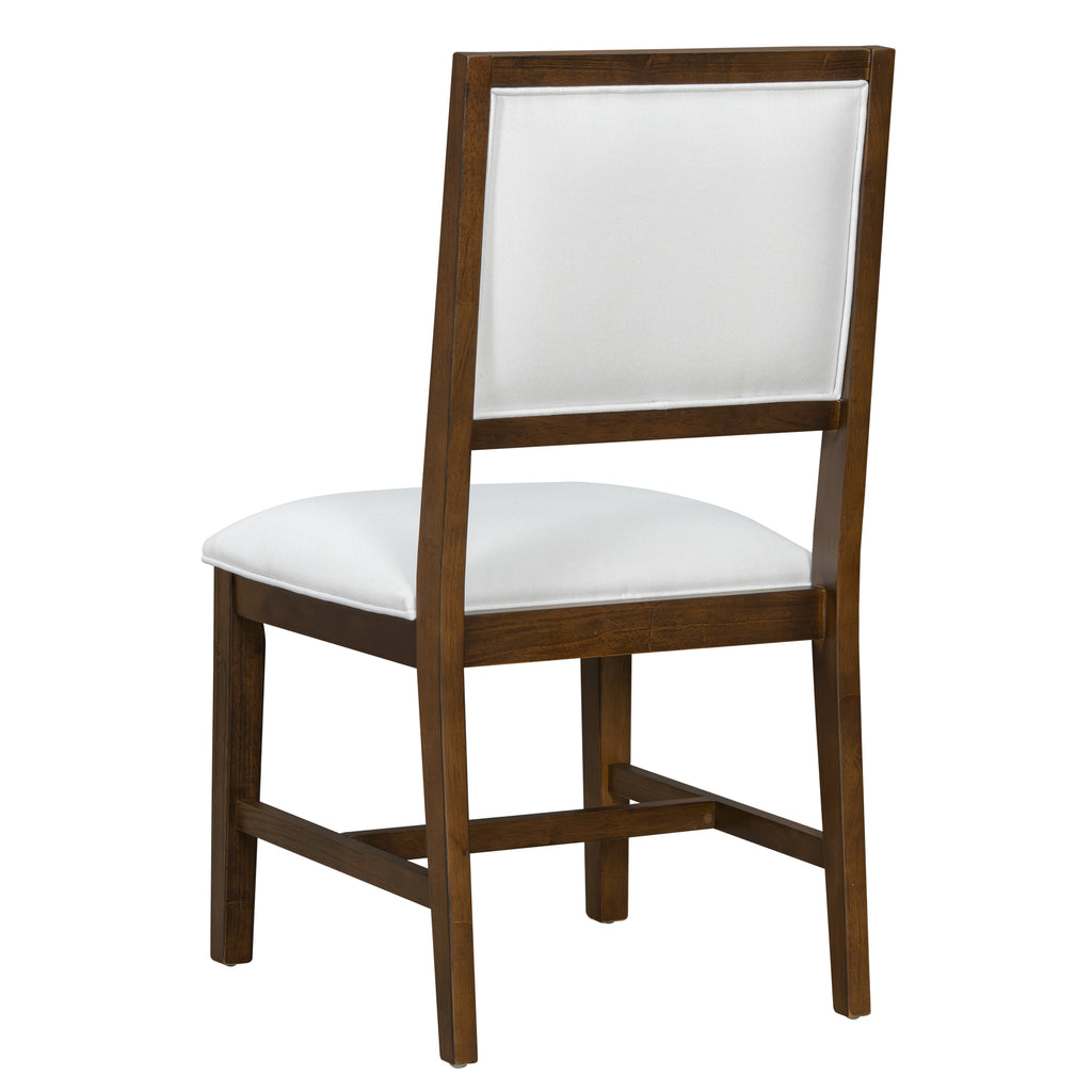 Rear view of farmhouse dining chair with white upholstery and solid wood frame. Complements farmhouse dining table sets.