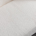 Close-up of plush textured upholstery on minimalist white curved sofa, showcasing soft and durable fabric.