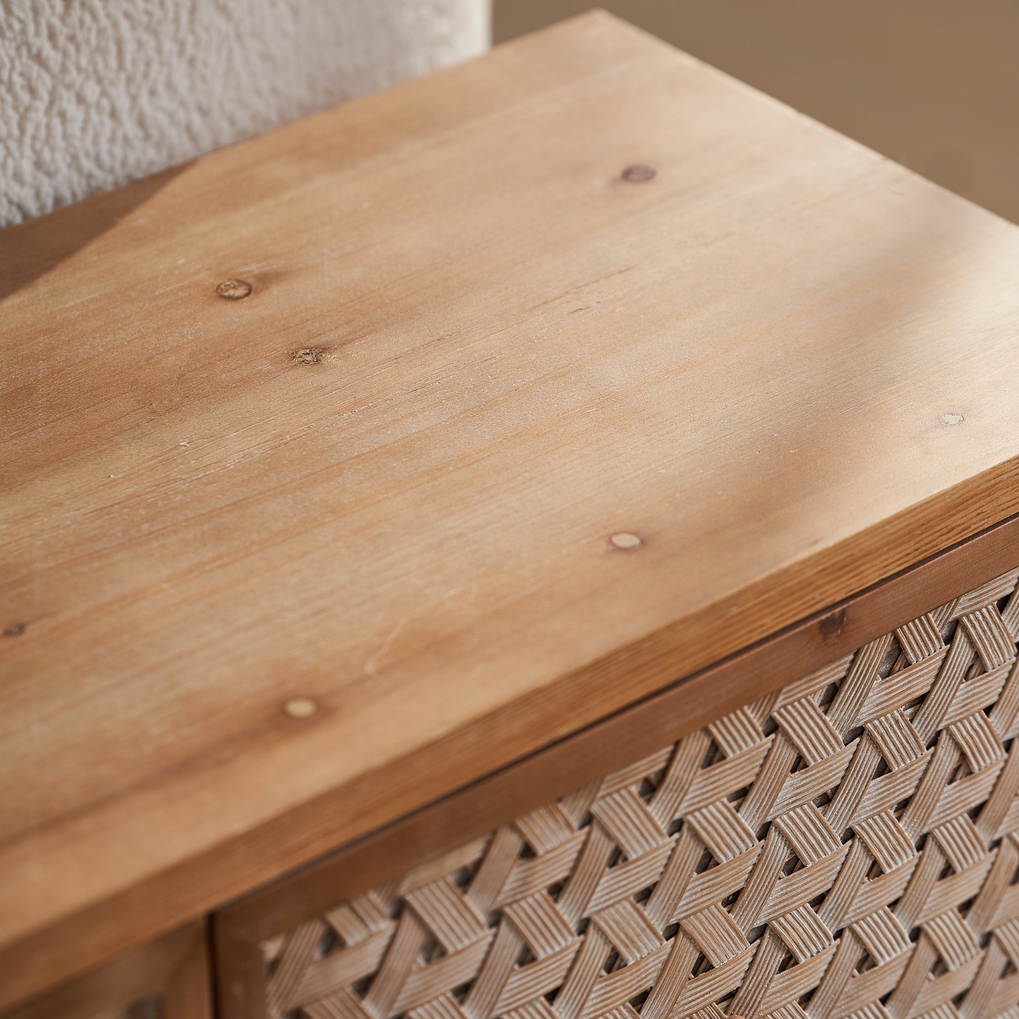 Detail of the natural wood grain on the Rattan TV Stand Mid Century with Storage, showcasing quality craftsmanship.