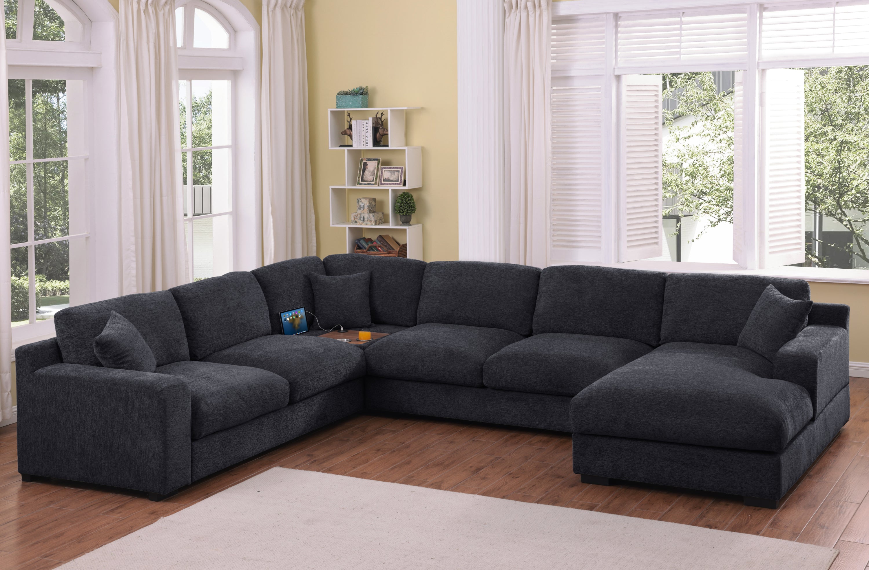 Celine Corner Sofa - Charcoal Sofa with Chaise in a bright living room, featuring USB ports, cupholders, and plush cushions for comfort.