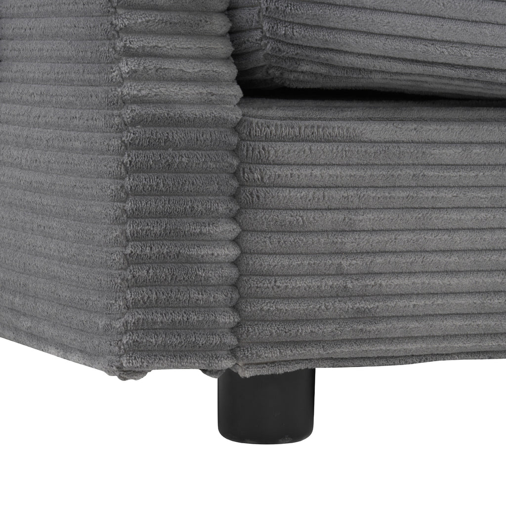 Corner detail of modular sofa base with ribbed corduroy fabric and black leg support for a sturdy, modern design.