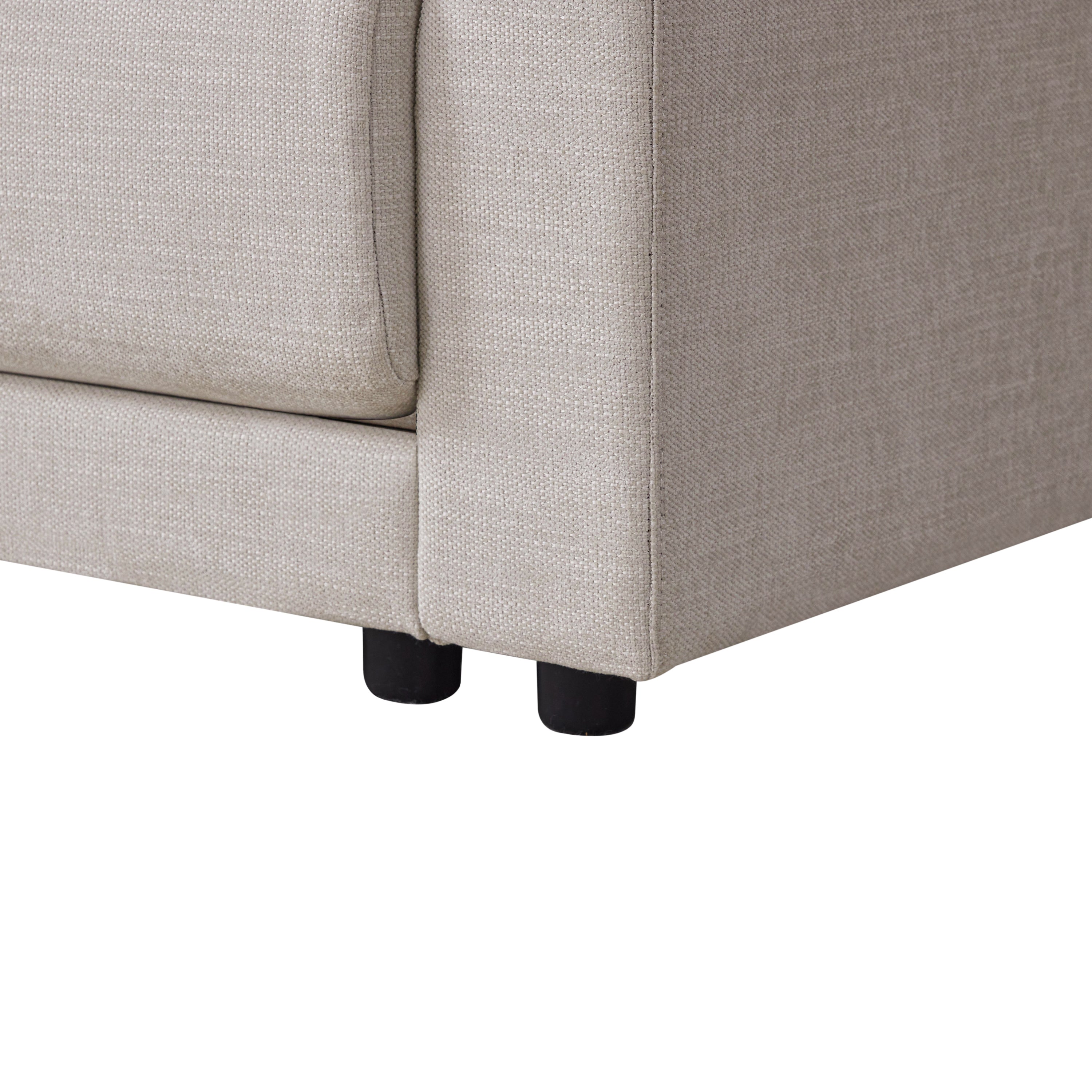 Detail of L-Shaped sectional sofa’s sturdy base and short black legs, showcasing its durable construction and modern design.