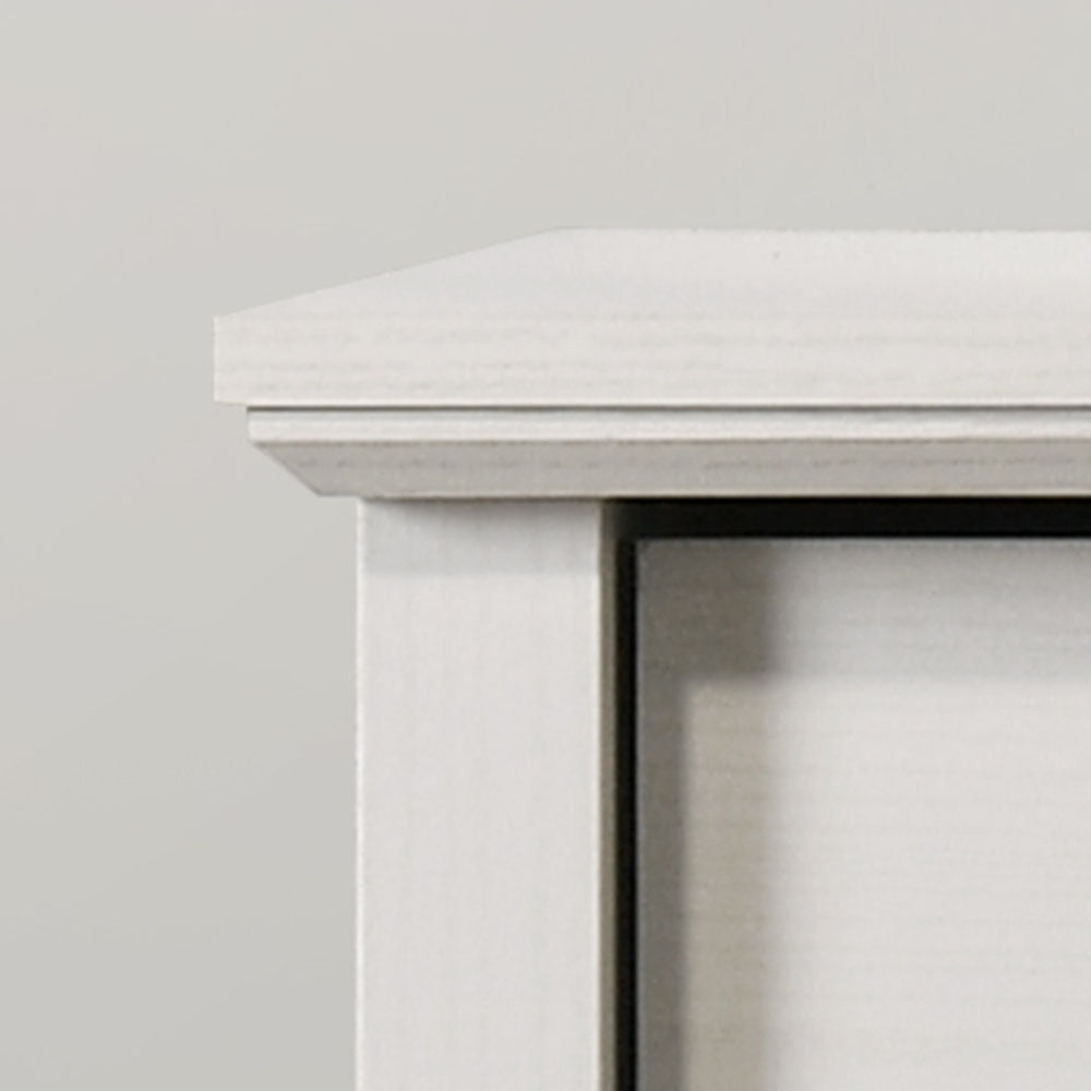 Close-up of the top corner of Elara White 4-Drawer Chest showing beveled edge and fine wood craftsmanship.