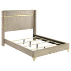 Beige upholstered queen wingback bed with vertical channel tufting, gold trim accents, and retro gold hairpin legs.