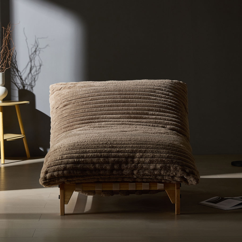 Front view of corduroy accent chair in low light, highlighting its soft texture and ergonomic shape for cozy living spaces.