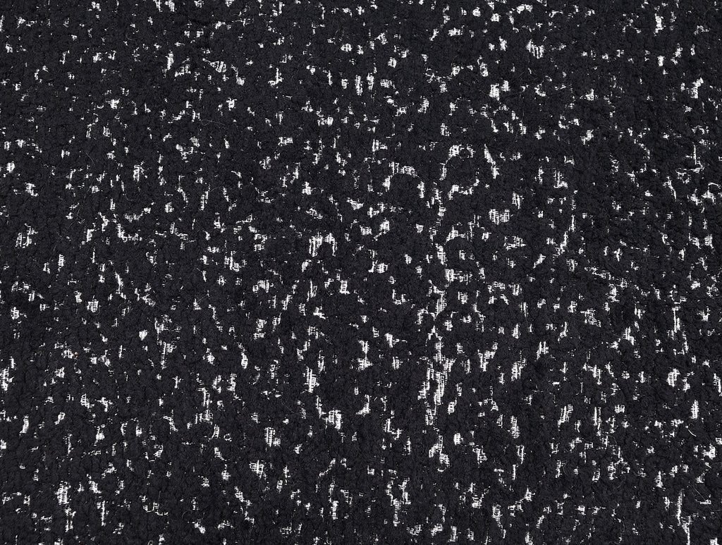 Close-up of black boucle fabric texture on swivel chair. Durable and stylish upholstery enhances the chair’s contemporary appeal.