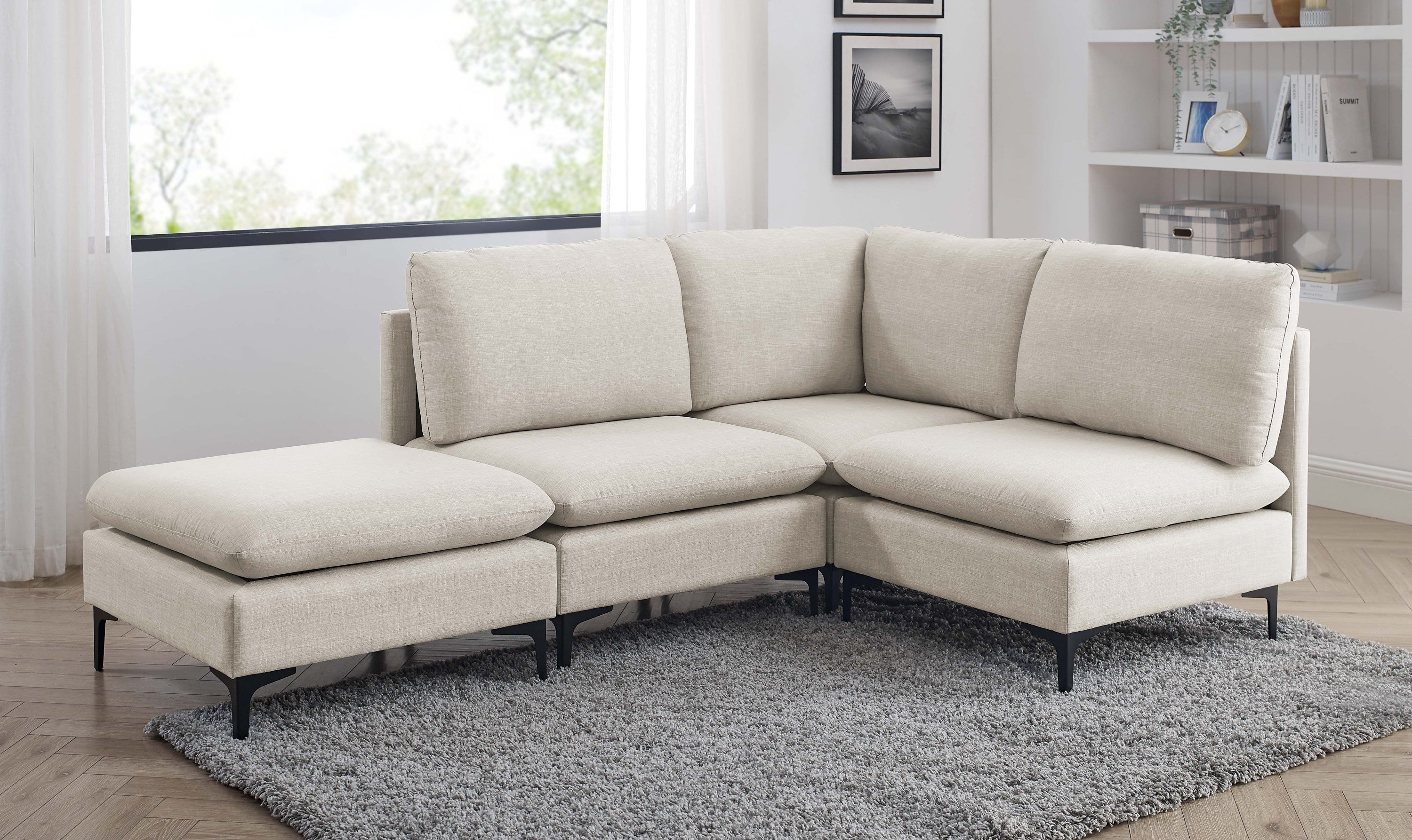 Beige linen modular sectional sofa featuring plush cushions and sleek black metal legs on a grey shag rug.