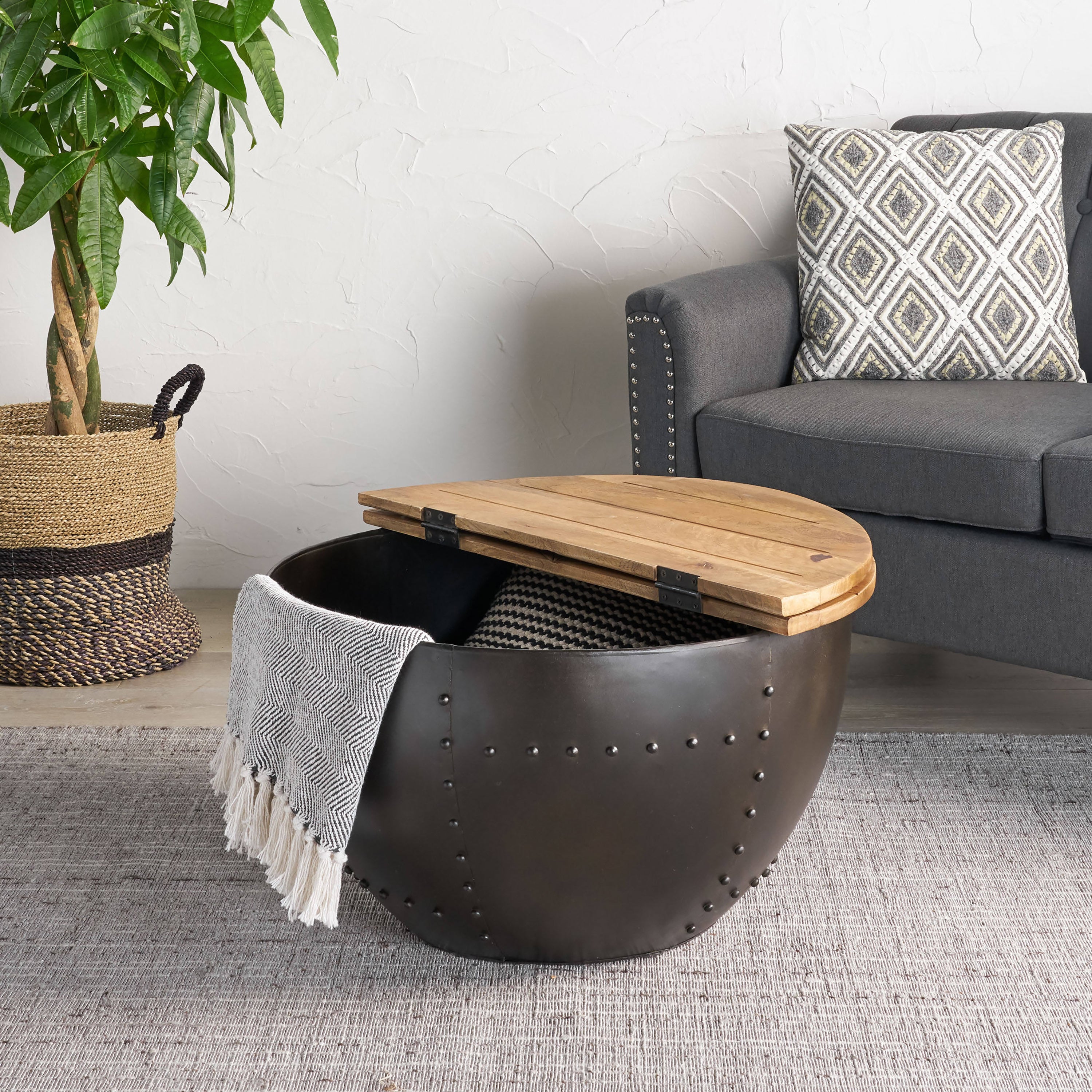 Wooden & Iron Coffee Table - Modern Industrial | Sturdy Metal Base shown in living room with open hinged top revealing storage space.